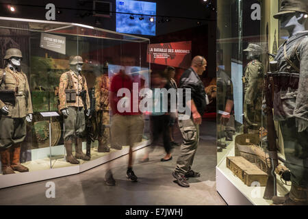 Tourists with audio guides visiting the Bastogne War Museum about World War Two Battle of the Bulge, Belgian Ardennes, Belgium Stock Photo