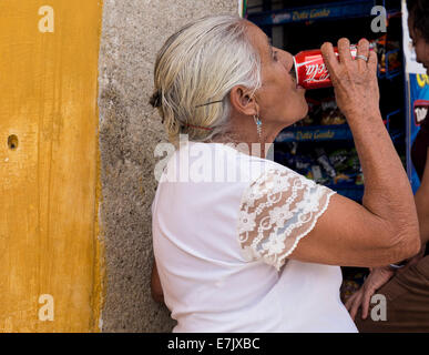 Woman drinking a coca-cola can in Antigua, Guatemala Stock Photo