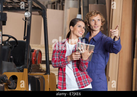 Carpenters With Digital Tablet Planning In Workshop Stock Photo