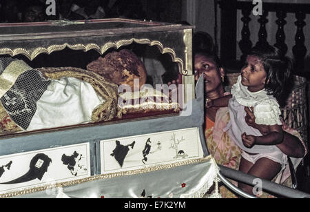 The body of Saint Francis Xavier is viewed through its glass and silver casket in 1974 inside the Se Cathedral after being brought from its final resting place in the nearby  Basilica Bom Jesus during the Solemn Exposition of his sacred relics that occurs every 10 years in Goa, India. As the first Jesuit missionary and co-founder of the Society of Jesus, Xavier arrived in Goa in 1542 to restore Christianity to the Portuguese settlers there and elsewhere in Asia. The Pope declared him a saint 70 years after his death in 1552. Historical photo. Stock Photo
