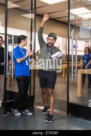 Los Angeles, USA. 19th Sep, 2014. An Apple fan cheers for buying an iphone 6 smartphone at an Apple store in Los Angeles, California, the United States, on Sept. 19, 2014. Apple's iPhone 6 and iPhone 6 Plus went on sale on Friday in the country. Credit:  Zhao Hanrong/Xinhua/Alamy Live News Stock Photo