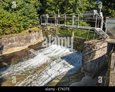 Small hydroelectric dam on a river in Switzerland Stock Photo