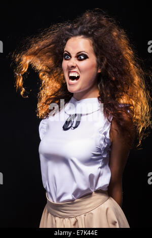 angry screaming vampire woman in dark Stock Photo