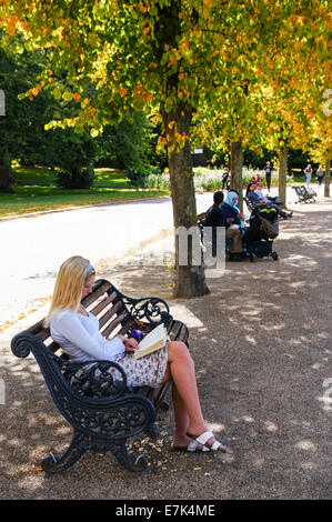 Visitors enjoy late summer colours in Victoria Park, London England United Kingdom UK Stock Photo