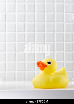 Yellow rubber duck on a tiled background Stock Photo