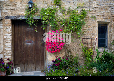 Milk bottles at front door of cottage in Castle Combe, the Cotswolds, Wiltshire, England Stock Photo