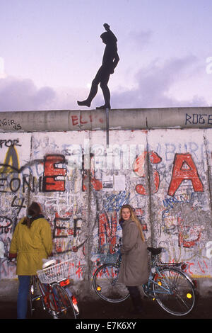 West Berlin, Germany. 17th Sep, 2013. People walk under a silhouette of a man walking on top of the Berlin Wall on Nov. 22, 1989 in Berlin. On Nov. 9, 1989 the Berlin Wall and the intra-German borders were open for free passage for the first time in nearly 40 years. ©1989 Scott A. Miller. © Scott A. Miller/ZUMA Wire/ZUMAPRESS.com/Alamy Live News Stock Photo