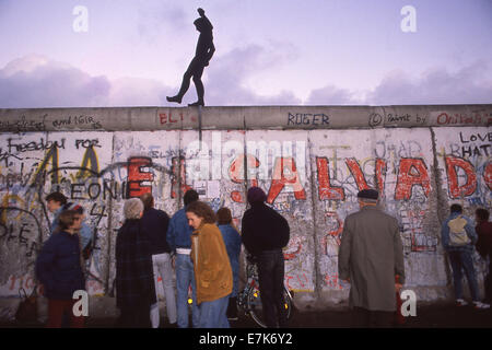 West Berlin, Germany. 17th Sep, 2013. People walk under a silhouette of a man walking on top of the Berlin Wall on Nov. 22, 1989 in Berlin. On Nov. 9, 1989 the Berlin Wall and the intra-German borders were open for free passage for the first time in nearly 40 years. ©1989 Scott A. Miller. © Scott A. Miller/ZUMA Wire/ZUMAPRESS.com/Alamy Live News Stock Photo