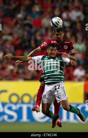 Tijuana, Mexico. 19th Sep, 2014. Javier Gandolfi (above) of Xolos vies for the bal with Javier Orozco of Santos in a Journey 8 match during the MX League Aperture Tournament 2014, at Caliente Stadium, in Tijuana City, northern Mexico, on Sept. 19, 2014. © Guillermo Arias/Xinhua/Alamy Live News Stock Photo