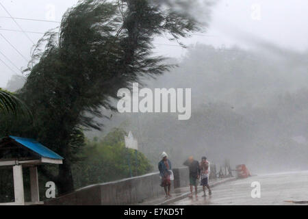 Ilocos Norte, Philippines. 20th Sep, 2014. Residents walk on a street in typhoon Fung-Wong in Ilocos Norte Province, the Philippines, Sept. 20, 2014. Typhoo Fung-Wong, which was enhanced by southwest monsoon, left at least seven people dead in the northern parts of the Philippines, including Metro Manila, the state disaster management agency said Saturday. Credit:  Rouelle Umali/Xinhua/Alamy Live News Stock Photo