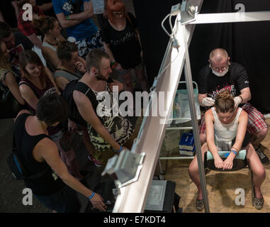 Piercing show during the second day of Cropp Tattoo Konwent - tattoo convention in Gdansk, Poland Stock Photo