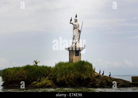 Birds on the Statue of Salvador del Mundo on the coast of Livingston, Guatemala Stock Photo