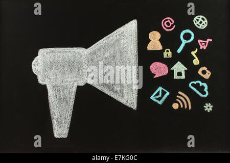 Chalk megaphone with flying icons drawn on blackboard by hand not in photoshop Stock Photo