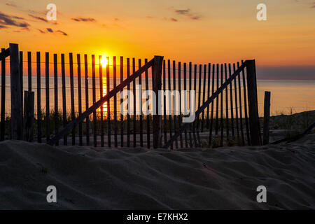 Wooden fence with sunset sky in Cape Cod near Provincetown Stock Photo
