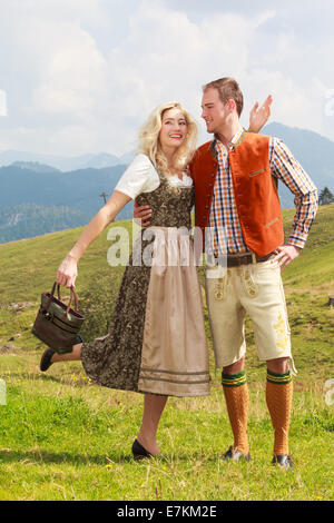 Bavarian couple in fashionable lederhosen and dirndl Stock Photo