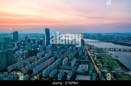 The skyscrapers of Seoul light up as evening comes on in South Korea. Stock Photo