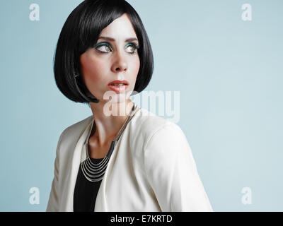 Close up portrait of beautiful young woman wearing white jacket - studio shot Stock Photo
