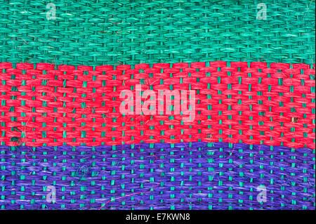 Red, green and blue stripes on a straw texture Stock Photo