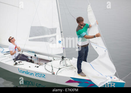 The Andrew Simpson Sailing Centre, Weymouth and Portland National Sailing Academy, Dorset, UK. 20th September, 2014. British gold medalists Paul Goodison MBE (Left) and Iain Percy OBE (Right) preparing for the Bart's Bash sailing event on Sunday 21 September 2014. Credit:  Jak Bennett/Alamy Live News Stock Photo