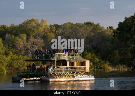 Cruise along the Victoria Falls aboard the ' African Queen'.  Other boats sailing in the Zambezi River. Take a Sunset Cruise dow Stock Photo