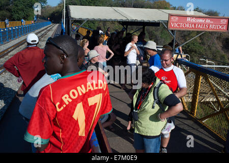 People around Victoria Falls Bridge. The Victoria Falls Bridge crosses the Zambezi River just below the Victoria Falls and is bu Stock Photo