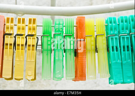 Colorful clothes pegs on a line with water drops Stock Photo