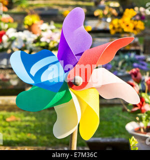 A colorful toy windmill in a garden Stock Photo