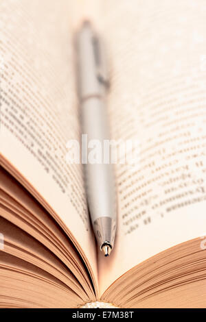 Close-up of open book and pen Stock Photo