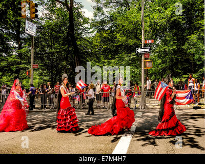Traditionally dressed young ladies march proudly up Fifth Avenue in the New York Puerto Rican Day parade  on a spring day in Manhattan, New York City. Note Puerto Rican flags. Stock Photo
