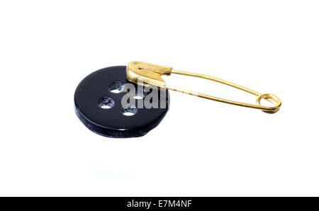 Black button and safety pin isolated on white Stock Photo