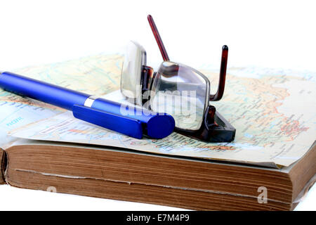Reading glasses over a book with a blue pen Stock Photo