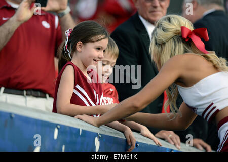 Morgantown, West Virginia, USA. 17th Feb, 2013. An Oklahoma Sooner cheerleader greets a young fan prior to the Big 12 conference football game being played at Mountaineer Field in Morgantown, WV. The Sooners beat the Mountaineers 45-33. © Ken Inness/ZUMA Wire/Alamy Live News Stock Photo