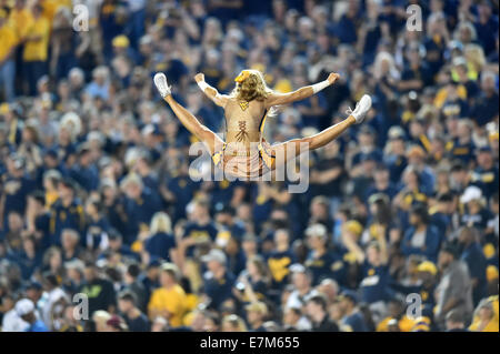 Morgantown, West Virginia, USA. 20th Sep, 2014. A WVU cheerleader soars in the air performing a stunt in front of fans in the Big 12 conference football game being played at Mountaineer Field in Morgantown, WV. The Sooners beat the Mountaineers 45-33. Credit:  Ken Inness/ZUMA Wire/Alamy Live News Stock Photo