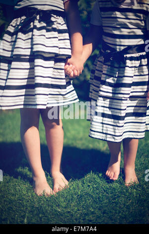 Girls holding hands. Exterior shot.