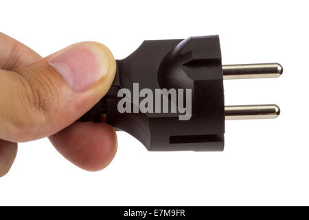 Isolated man hand holding a cable with European plug over white background Stock Photo