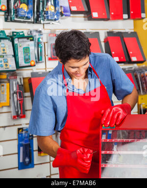 Salesman With Drill Bit And Toolbox In Store Stock Photo