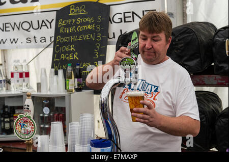 Barstaff pouring a pint of beer at the Newquay Fish Festival in Newquay Harbour. Stock Photo