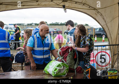 Security checking bags at the Brownstock Festival in Essex. Stock Photo