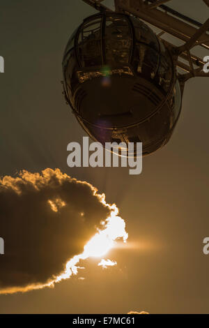 London Eye pod partially silhouetted by the setting sun Stock Photo