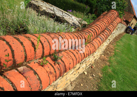 There are so many ways a garden wall can be built and so many different bricks, blocks and stone that can be used. Stock Photo