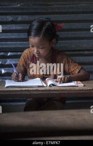 Bandorban, Bangladesh. 20th Sep, 2014. A tribal child is doing his homework Credit:  Zakir Hossain Chowdhury/ZUMA Wire/Alamy Live News Stock Photo