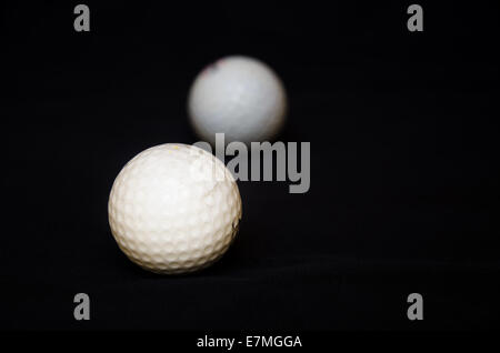 white golf ball on black background Stock Photo