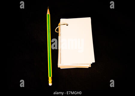 pencil and notebook on black background Stock Photo