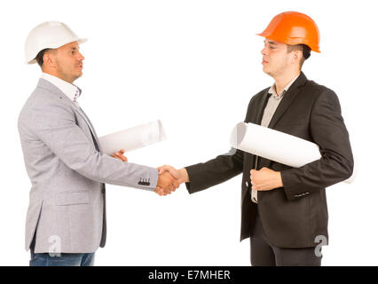 Middle Age Engineers in Gray and Black Attire Shaking Hands and Holding Blueprints. Isolated on White Background. Stock Photo