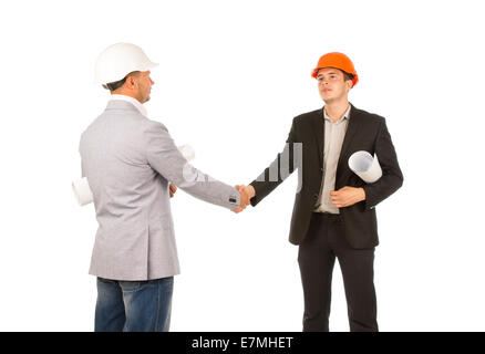 Two Caucasian Middle Age Engineers Shaking Hands with Blueprints. Isolated on White Background. Stock Photo