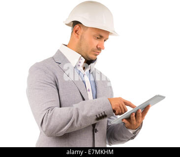 Side view of an architect or engineer using a tablet navigating the touch screen with his finger, isolated on white Stock Photo