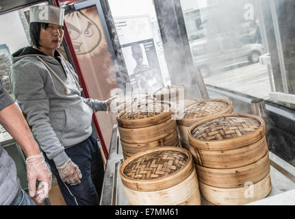 Warsaw, Poland. 21th September, 2014. Man prepares momo dumplings steamed in bamboo baskets during food trucks festival in front of Palace of Culture and Science in Warsaw. Credit:  kpzfoto/Ģ����ý Live News Stock Photo
