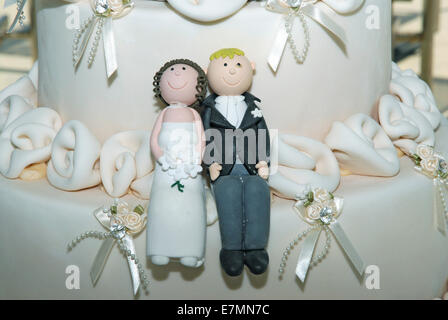 Bride and groom figures on wedding cake (detail) Stock Photo