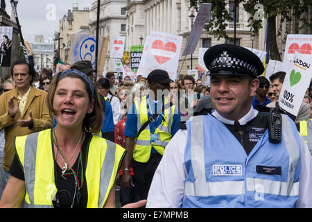 A steward walks next to a police liaison officer at the front of the Climate Change demonstration, London, 21st September 2014. © Sue Cunningham Stock Photo