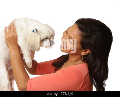 Beautiful woman holding her Shih Tzu-Maltese mixed breed dog, New York, USA, September 16, 2014, © Katharine Andriotis Stock Photo